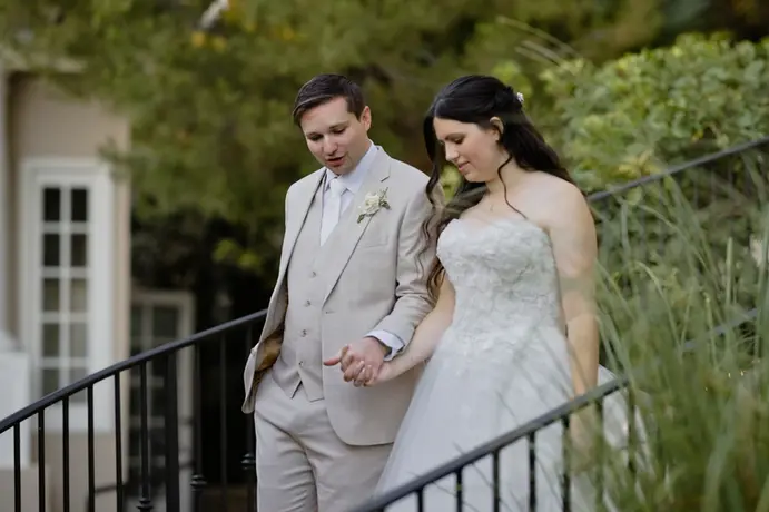 couple walk down stairs together after then spent a few minutes with each other after the ceremony