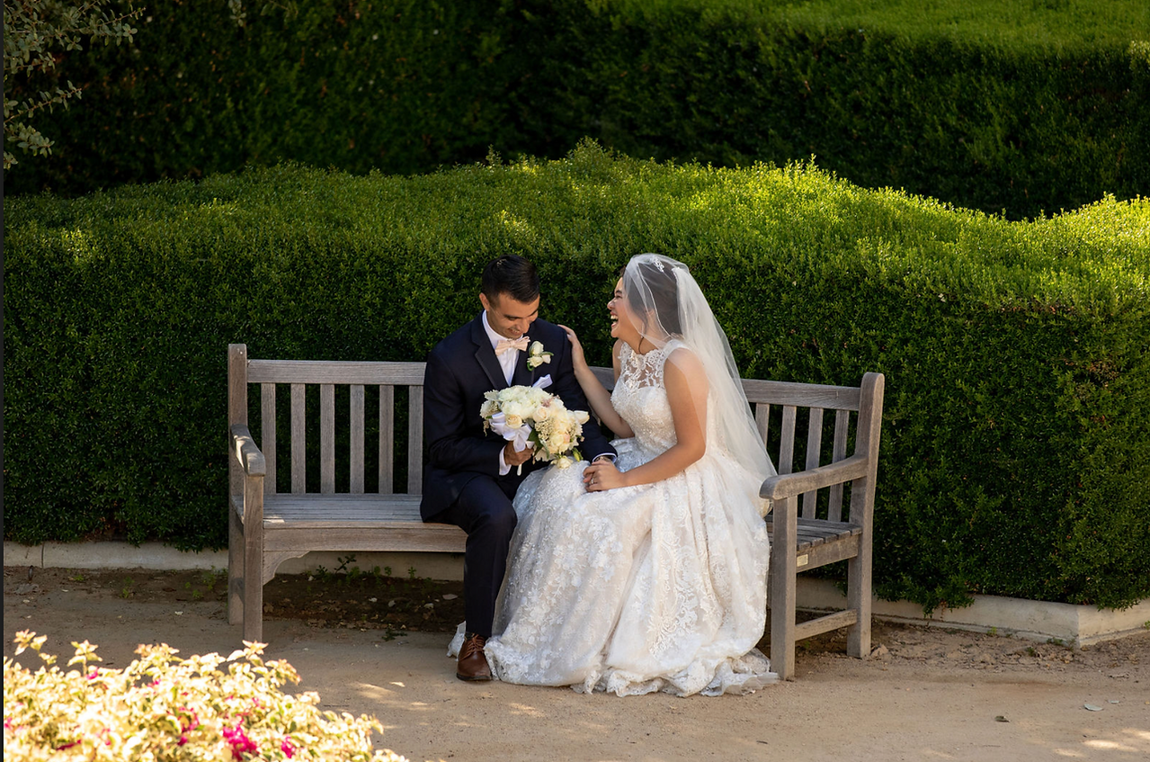 Happy newlyweds on a bench at Pasadena City Hall