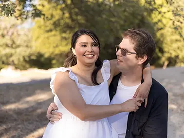 lake fulmor couples engagement session she is sitting on his lap they are laughing