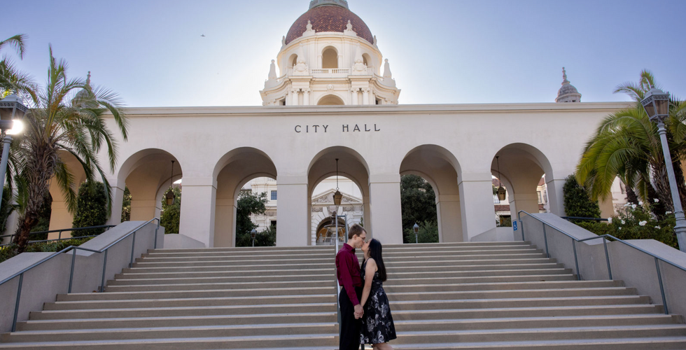 Couple kissing on steps of Pasadena City Hall for engagement photos.
