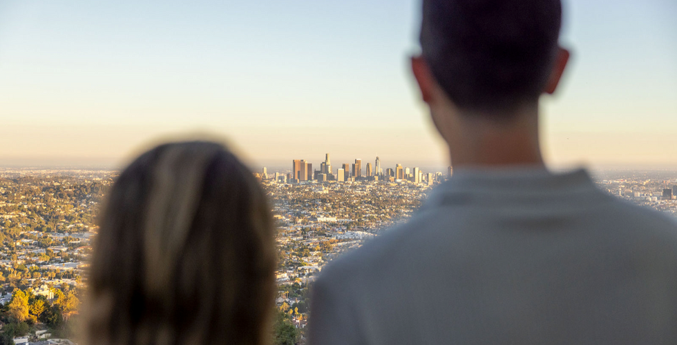Couple overlooking Los Angeles skyline, engagement photo location