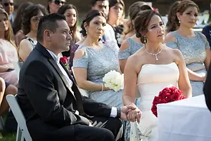 Wedding couple holding hands at ceremony