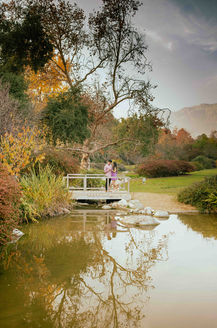 couple on bridge during their engagement session after he proposed
