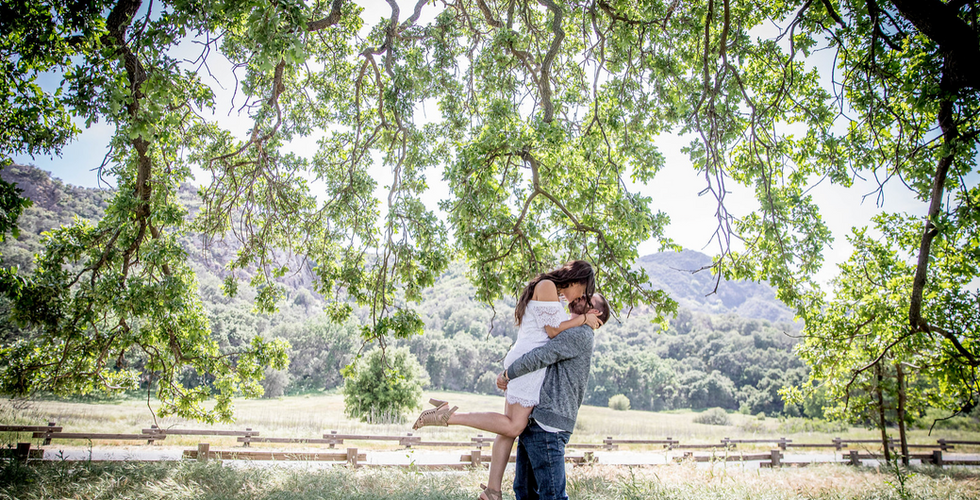 Couple kissing under a tree, beautiful engagement photo location
