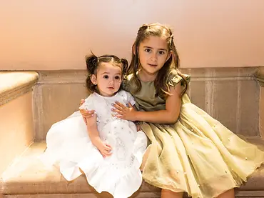 baptism with a young child and her sister sitting in a chapel of St. Andrews church pasade