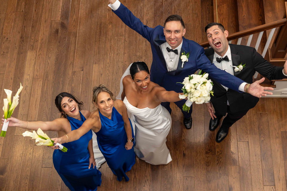 Newport Beach Wedding at the Yacht Club couple and their wedding party celebrate in the lobby