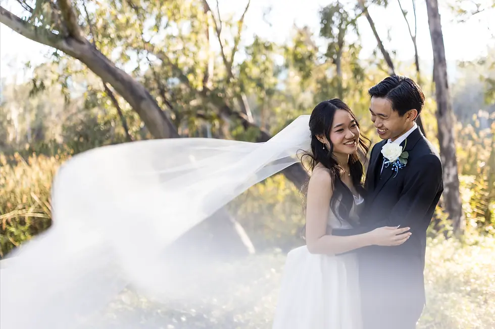 bride and groom alone after ceremony laughing with a forest lake behind them candid moment