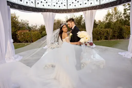 Wedding couple under a white gazebo