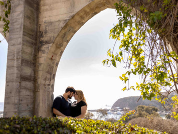 Last minute engagement session couple kissing under an archway in Dana Point Arches
