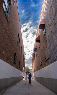 Couple in a narrow brick alley, a unique engagement photo location