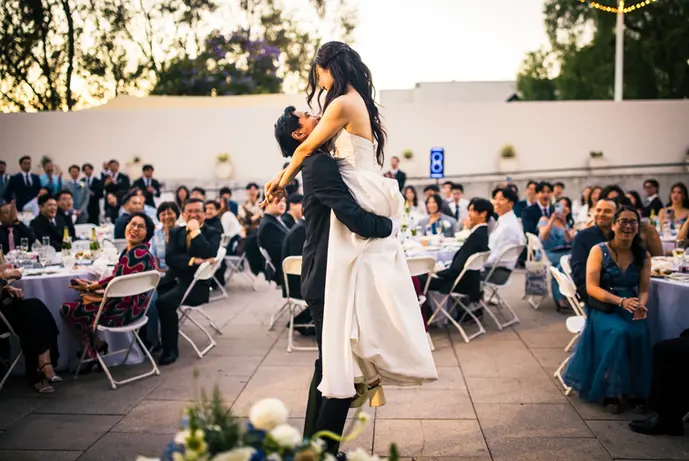 bride jumps into the grooms arms