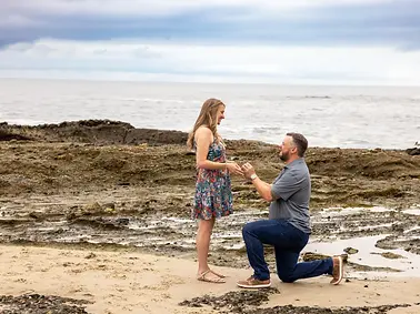 treasure island beach couple he is proposing to her and she said yes. She is wearing a dr