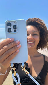 UGC Creator hält Smartphone mit Handyband in der Hand.