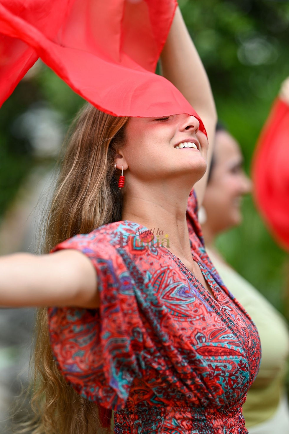 Pizzica dancer holding the traditional red scarf during a cultural performance in Puglia