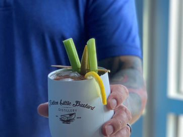 Gentleman with tattoos handing you a Bloody Mary