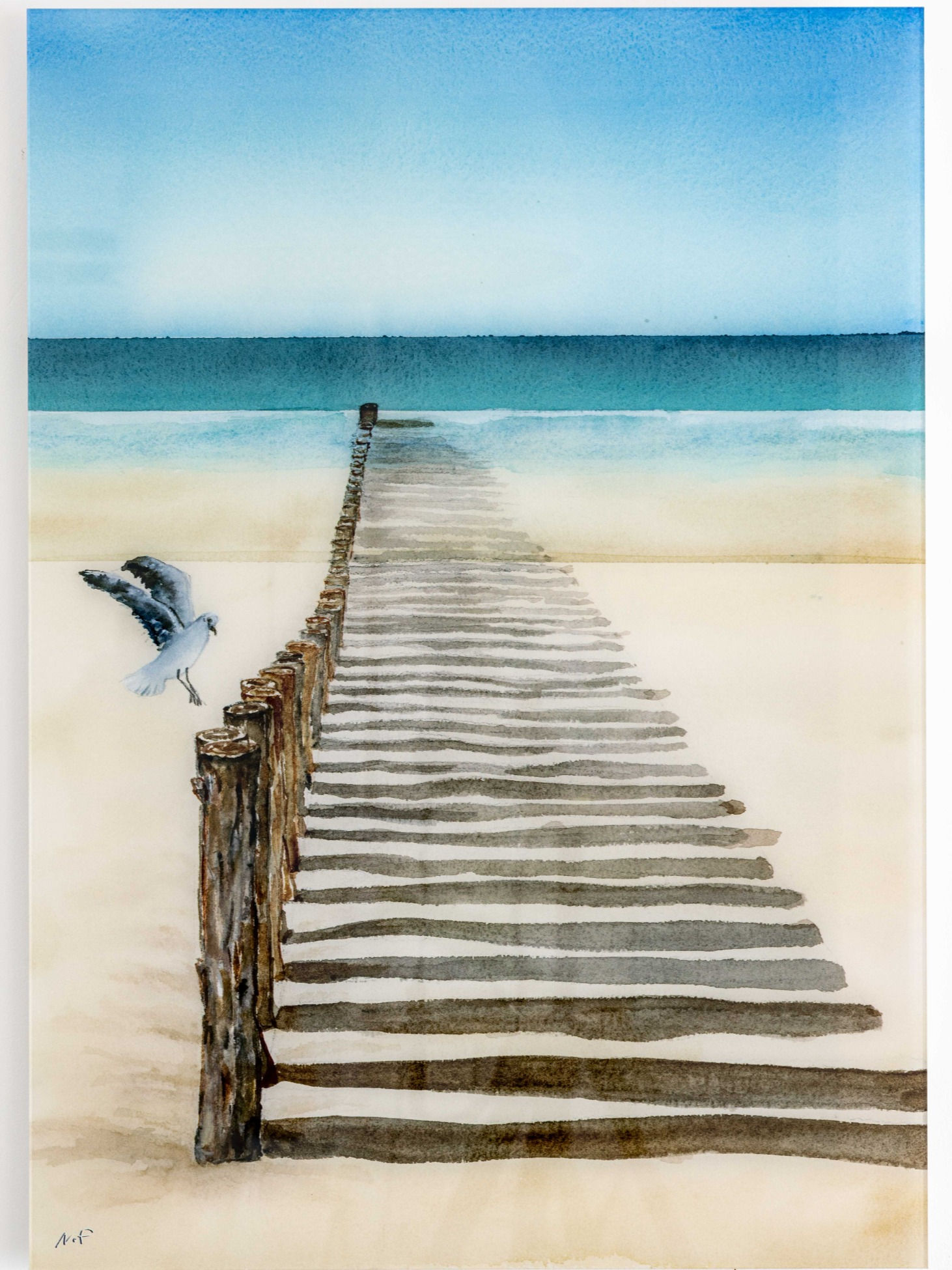 Bird landing on row of poles, on a beach