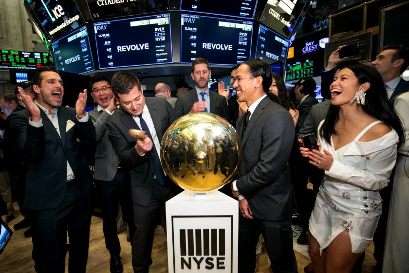 Revolve Group co-CEOs Mike Karanikolas, left, and Michael Mente, right, ring the opening bell at the NYSE on June 7. At far right is Chief Brand Officer Raissa Gerona.(Courtney Crow/NYSE)