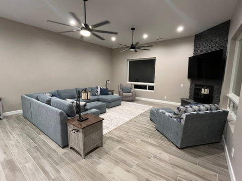 Spacious living room with sectional sofa, fireplace and hardwood floors
