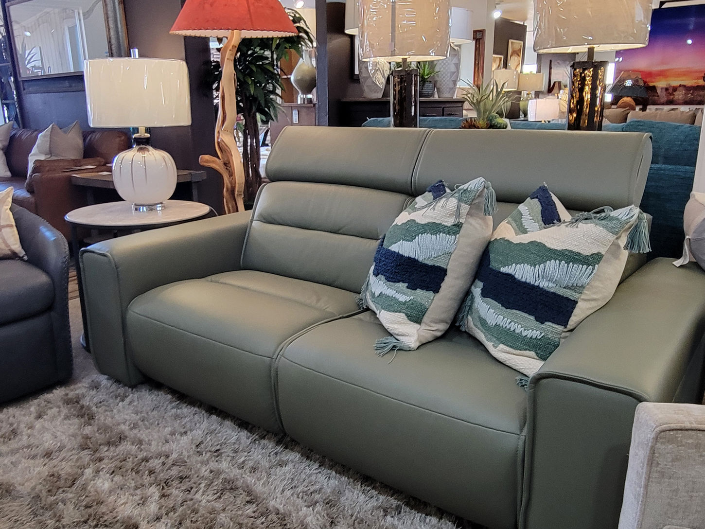 Green leather power reclining sofa with pillows