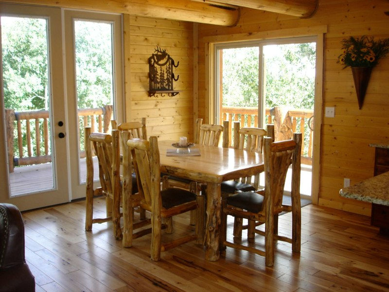 Rustic — Rustic wood dining table and chairs in a log cabin interior available at Designs West Home furniture store in Flagstaff