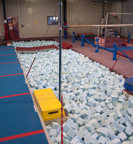 Gymnastics center foam pit and bars
