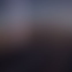 Cityscape at dusk with a glowing beam of light and a digital dome overlay. Radar and wave patterns are visible, suggesting a futuristic theme.