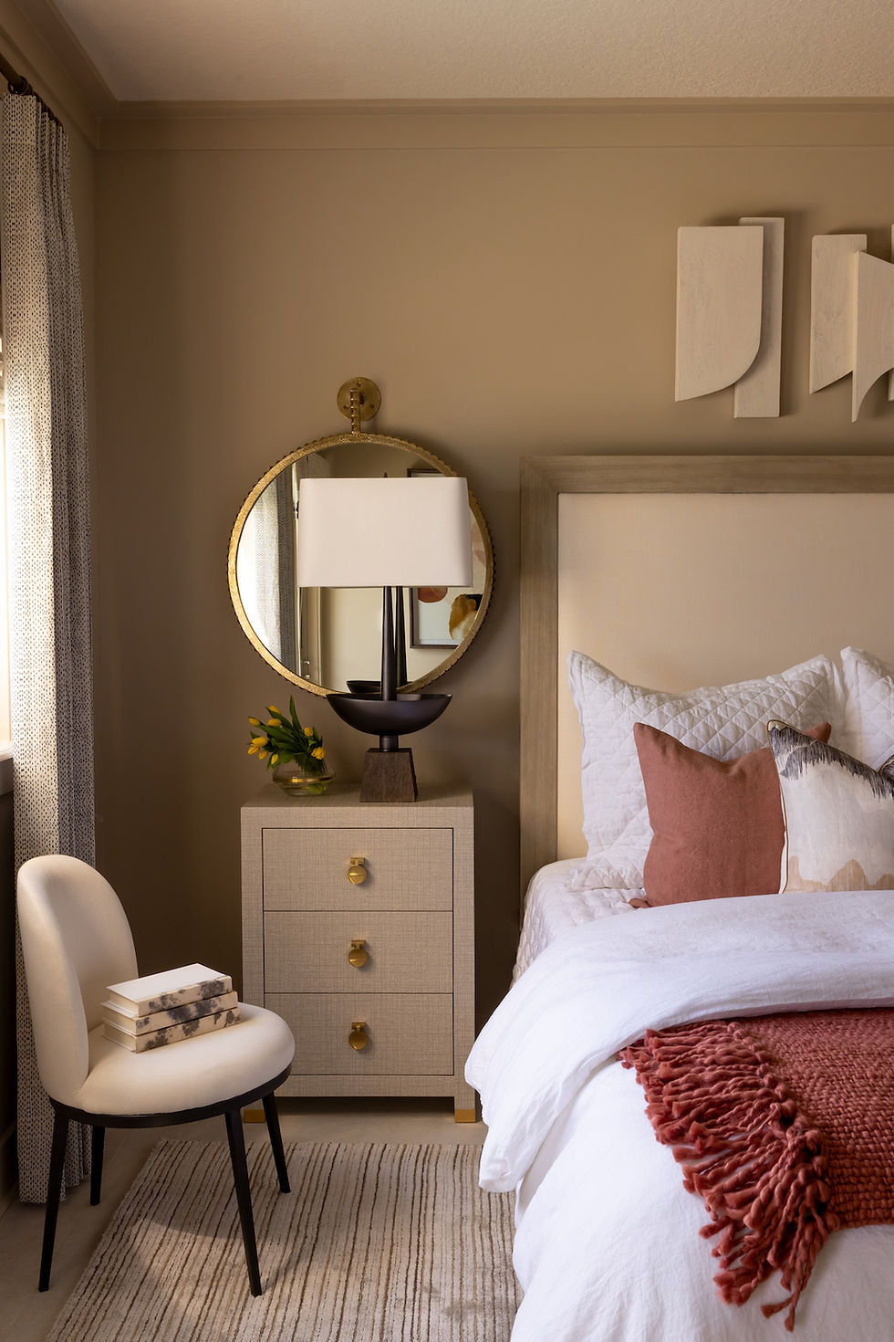Neutral bedroom with white bedding and rust colored accents