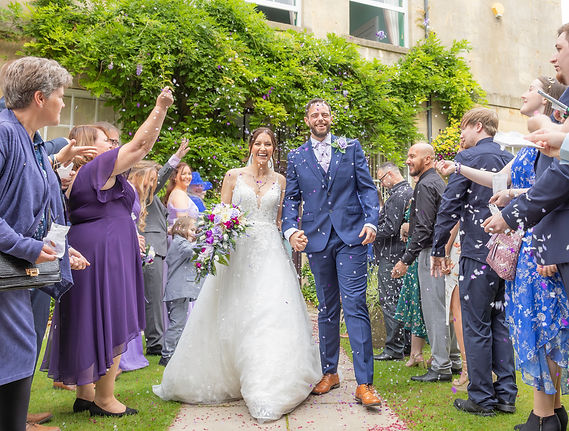 Wedding photograph, Bride & Groom, guests throwing confetti 
