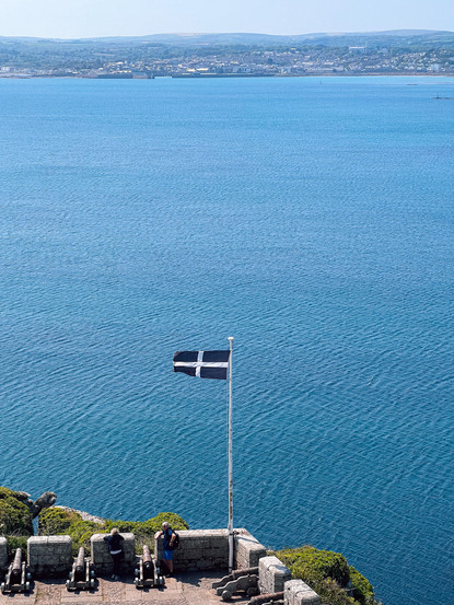 cornish flag by the ocean at st michael's mount in marazion, penzance in cornwall