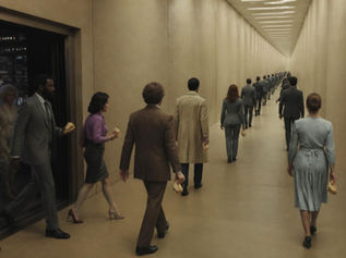 Business people carrying a sandwich in a corridor
