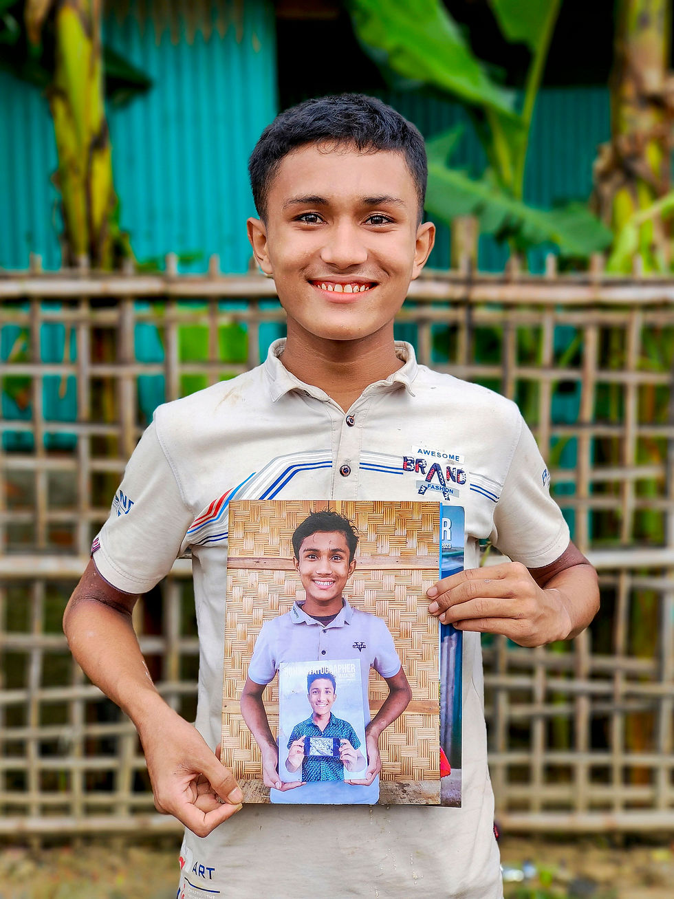 Md Asom, now nearly 18, holds a photograph of himself holding a photograph of himself as a child. The layered portrait traces the passage of time: children grow into adults, years pass, and lives continue. Yet for many Rohingya, the conditions shaping that childhood remain largely unchanged. 2024 © Sahat Zia Hero.