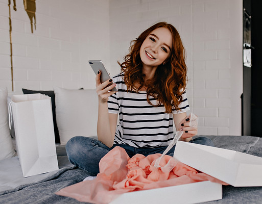 smiling-european-girl-posing-morning-with-smartphone-blithesome-lady-sitting-bed.jpg