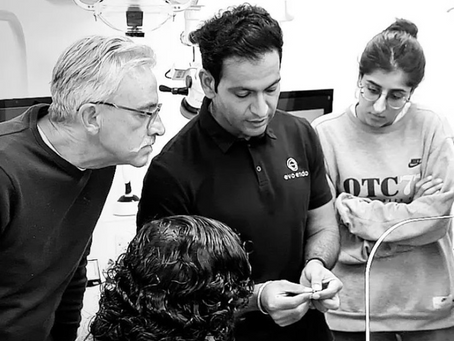 Dr Dhiraj Arora demonstrating an endodontic process in a training group of dentists