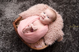 Newborn baby photographed in a cosy photography studio in Thatcham