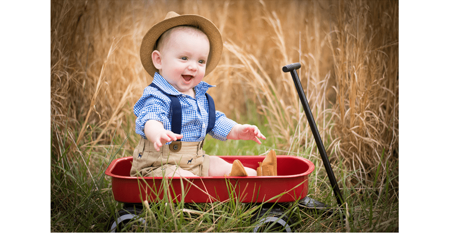 cute baby in a red wagon
