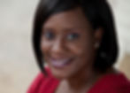 Professional headshot of woman in red in outdoor setting