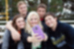 Teenagers taking a selfie while using a new wireless phone service