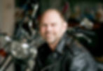 Lifestyle branding portrait of man posed in front of a motorcycle