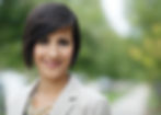 Professional outdoor headshot of woman with short dark hair