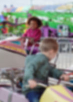 Children riding an amusement park attraction for a photo editorial print article