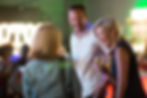 Guests chatting and laughing at a TED Talk event during editorial event coverage