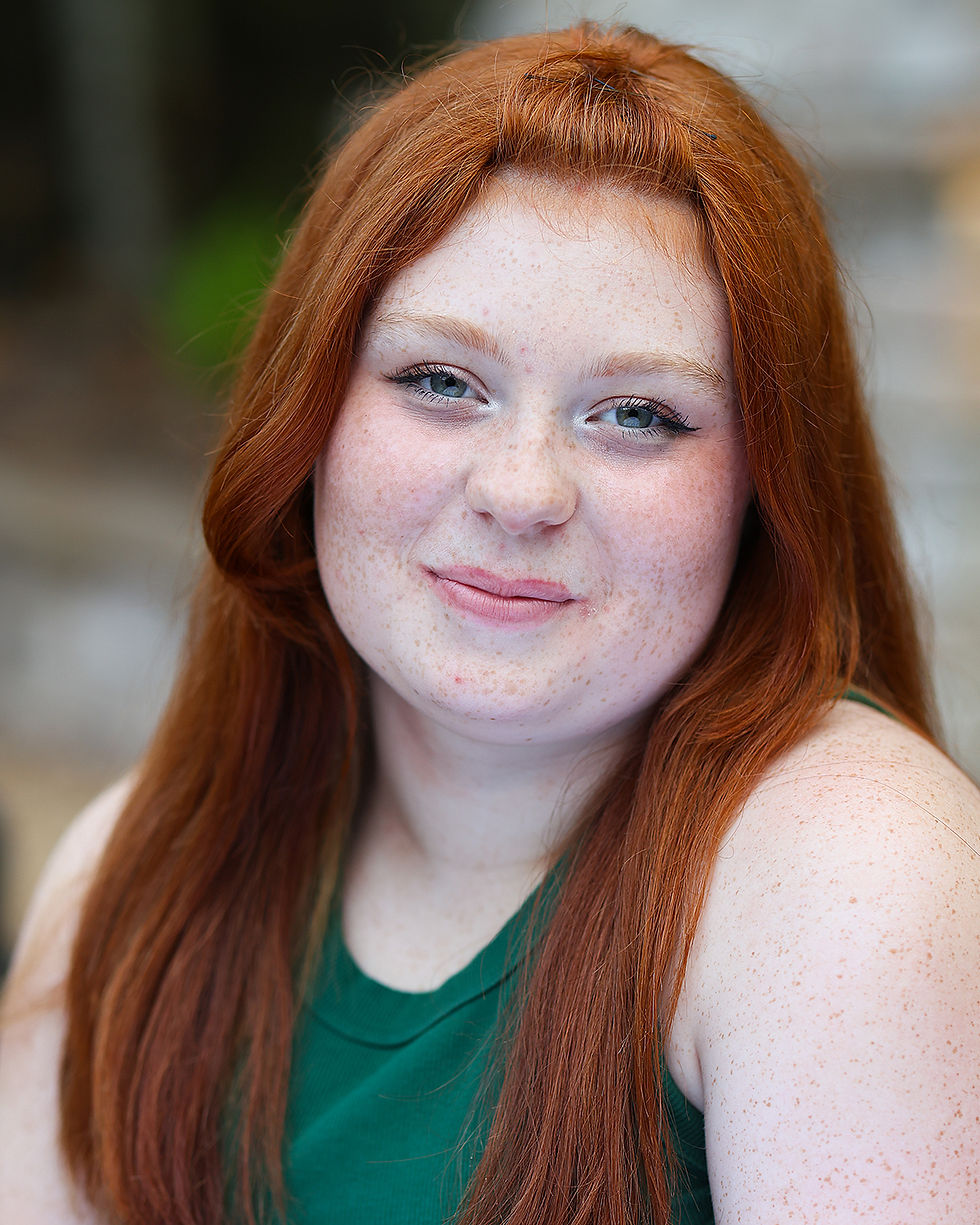 teen actor wearing green tank top with red hair