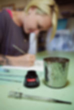 Artist creating an ink painting during a lifestyle editorial photography session