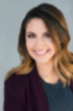 Professional headshot of smiling brunette woman