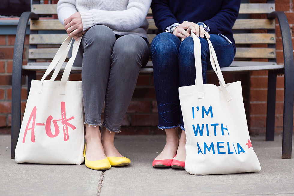 Close-up view of a canvas tote bag filled with everyday items on a park bench.