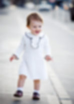 Child model wearing white clothing during a commercial fashion photography session
