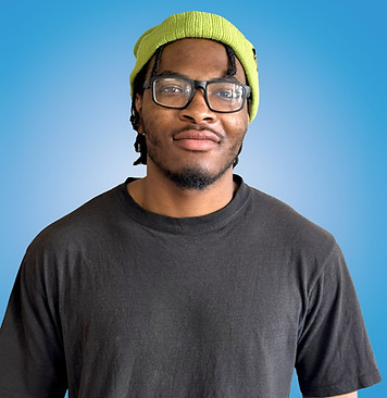 Intern smiling in front of blue background