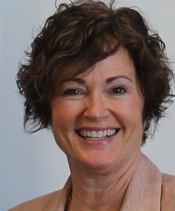 Kristi Haynes, smiling middle-aged white woman with short brown hair