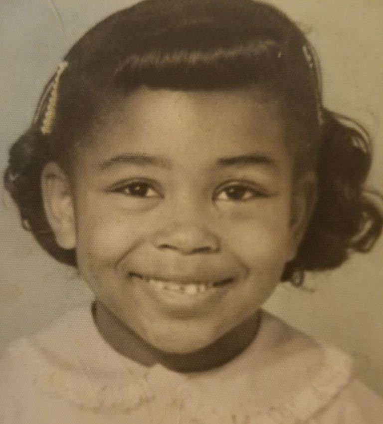 Myra Jolivet as a child, Black & white photo of smiling young black girl