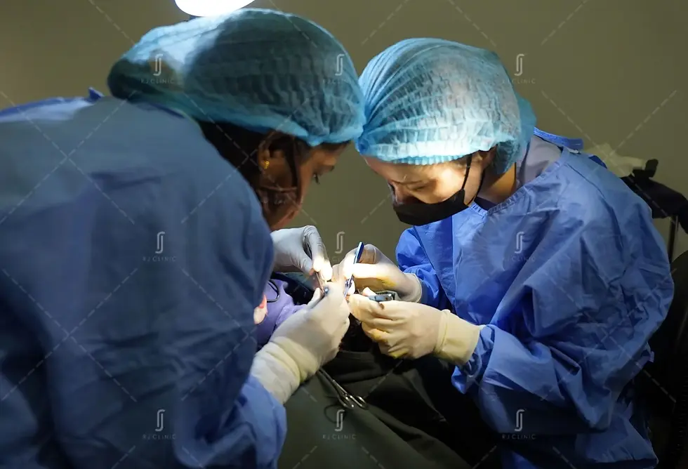 Medical team performing hair transplant procedure at RJ Clinic